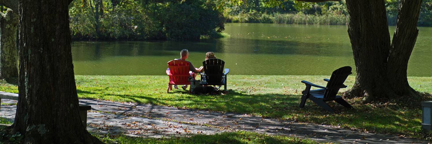 Two Peaks of Otter guests relax in Adirondack chairs