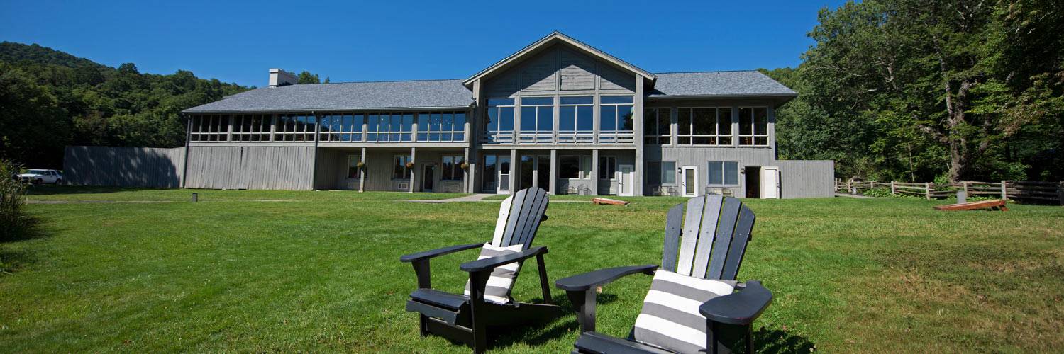 Peaks of Otter Lodge exterior with Adirondack chairs
